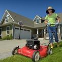 woman mowing lawn