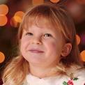 girl in front of Christmas tree