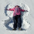 girl making snow angel